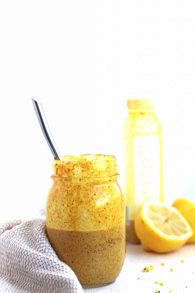 almond turmeric dressing in a mason jar with a lemon.