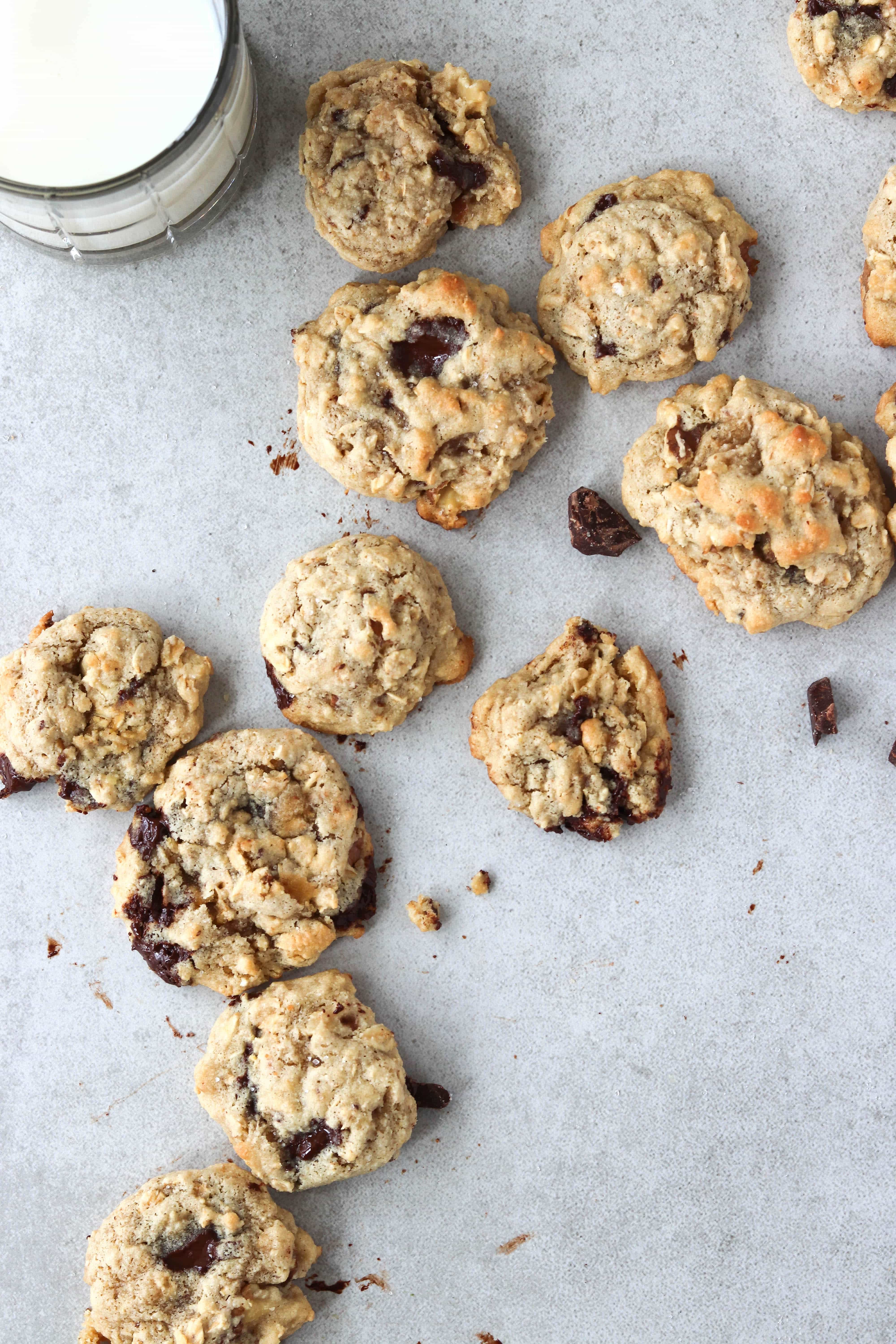 Overhead shot of oatmeal chocolate chip cookies with a glass of milk.