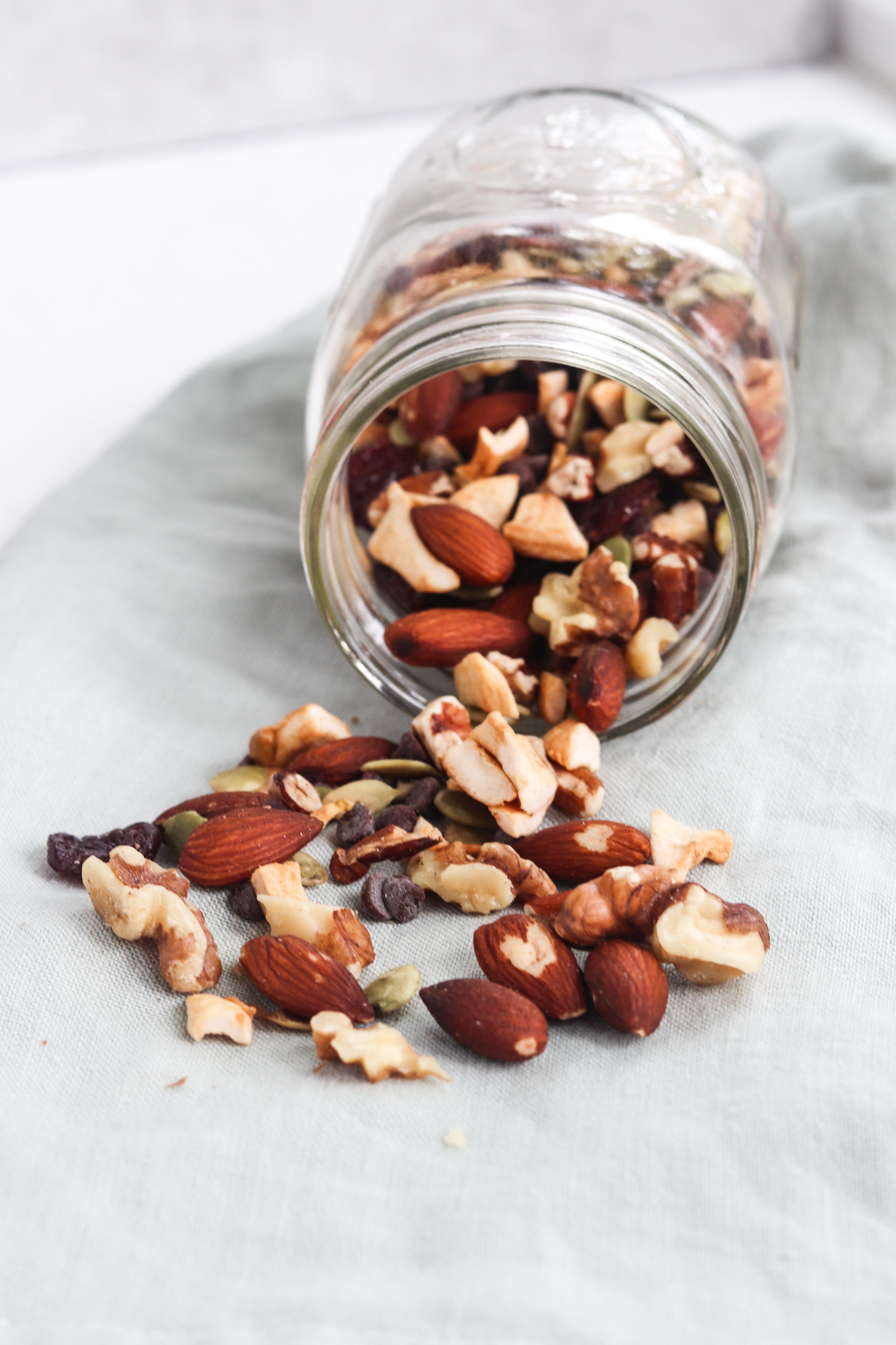 Nuts and trail mix coming out of a mason jar. 