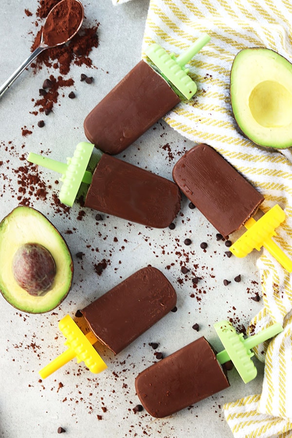 avocados and fudgesicles with a towel and chocolate around them. 