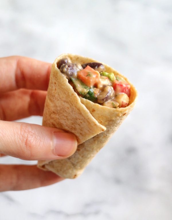 burrito being held by a hand.