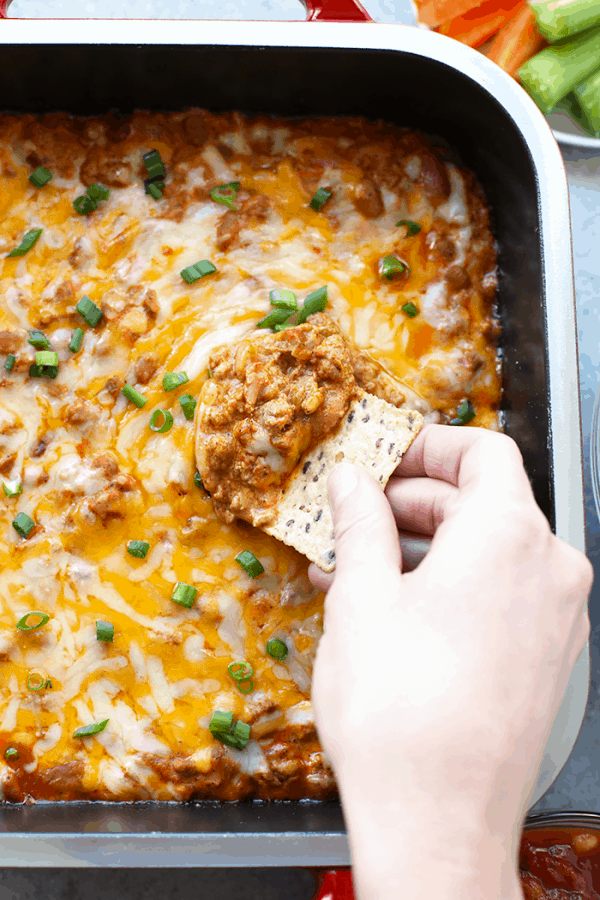 cheesy dip with a cracker and scallions on top.